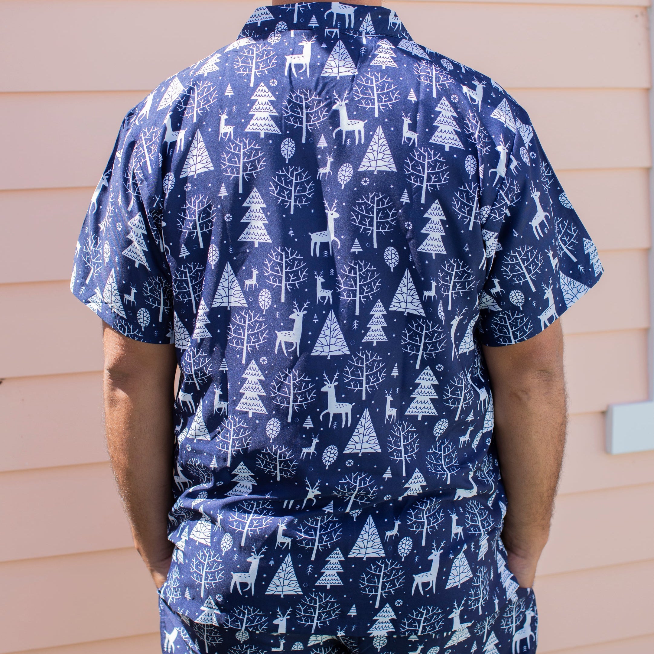 Navy Christmas adult shirt featuring white reindeer and tree patterns, festive tropical holiday style. | Tropicool Clothing