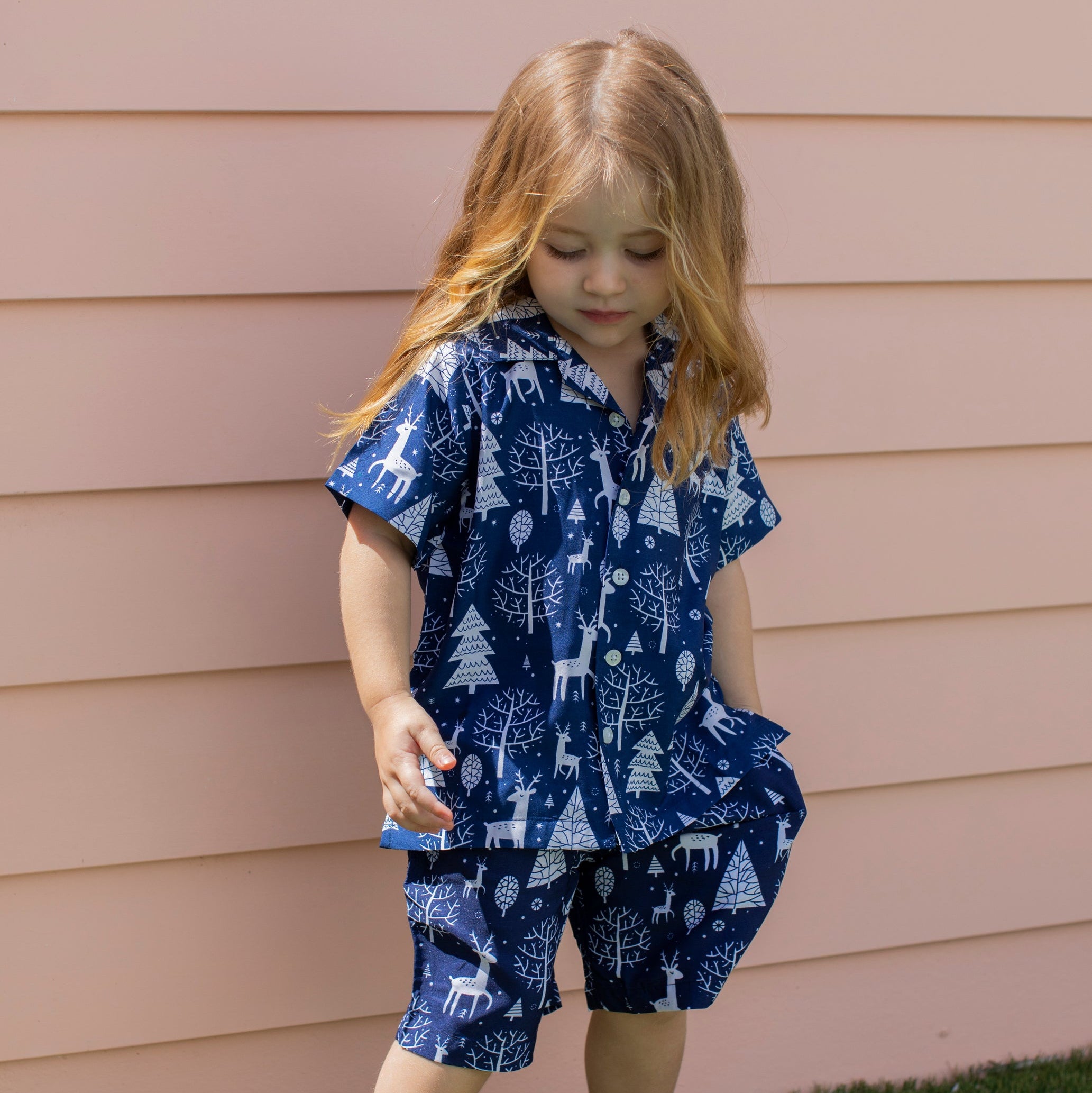 Navy Christmas kids shirt with festive reindeer pattern, short sleeves, holiday tropical style. | Tropicool Clothing