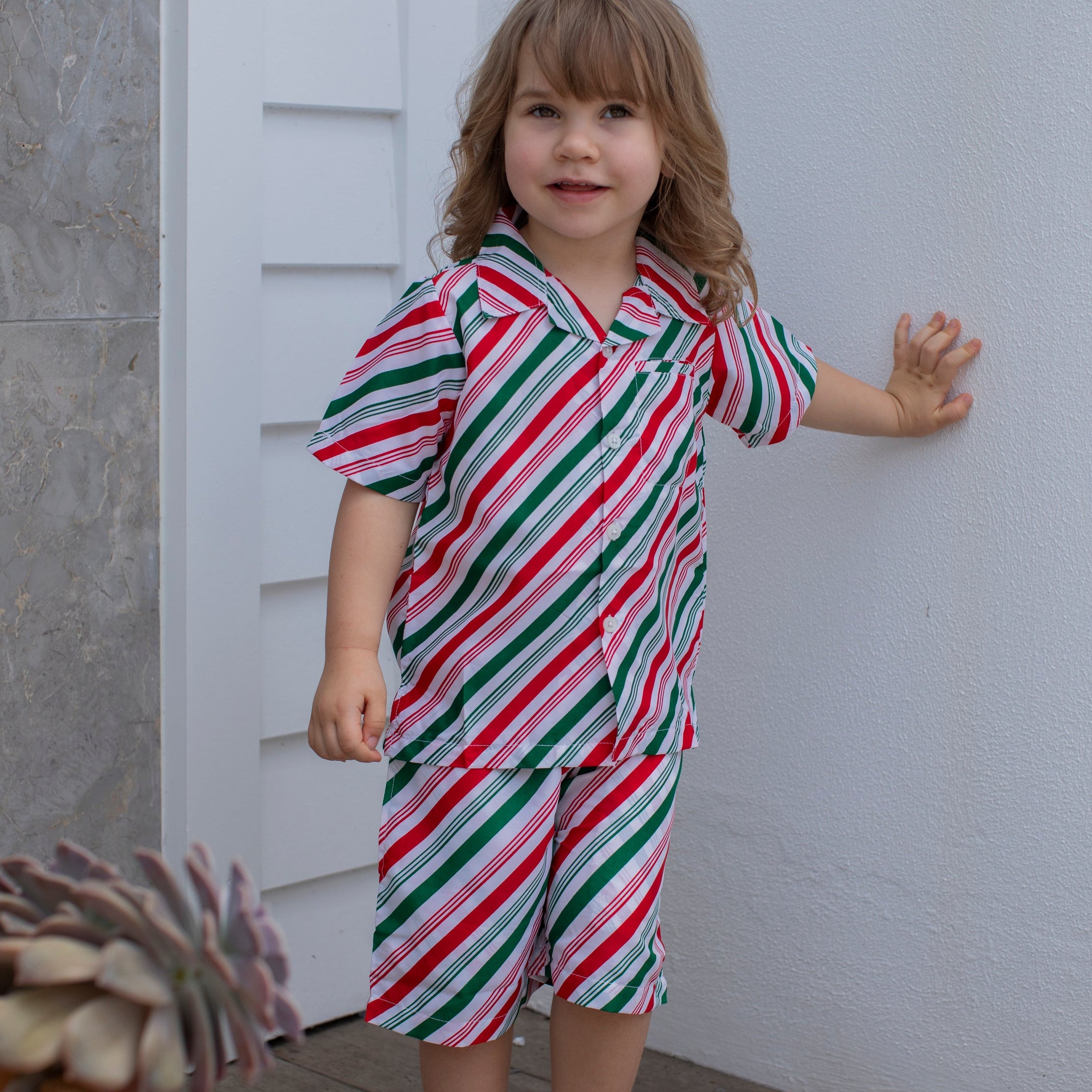 Jolly Stripe Christmas Kids Shorts with red, green, and white festive stripes; tropical holiday style. | Tropicool Clothing
