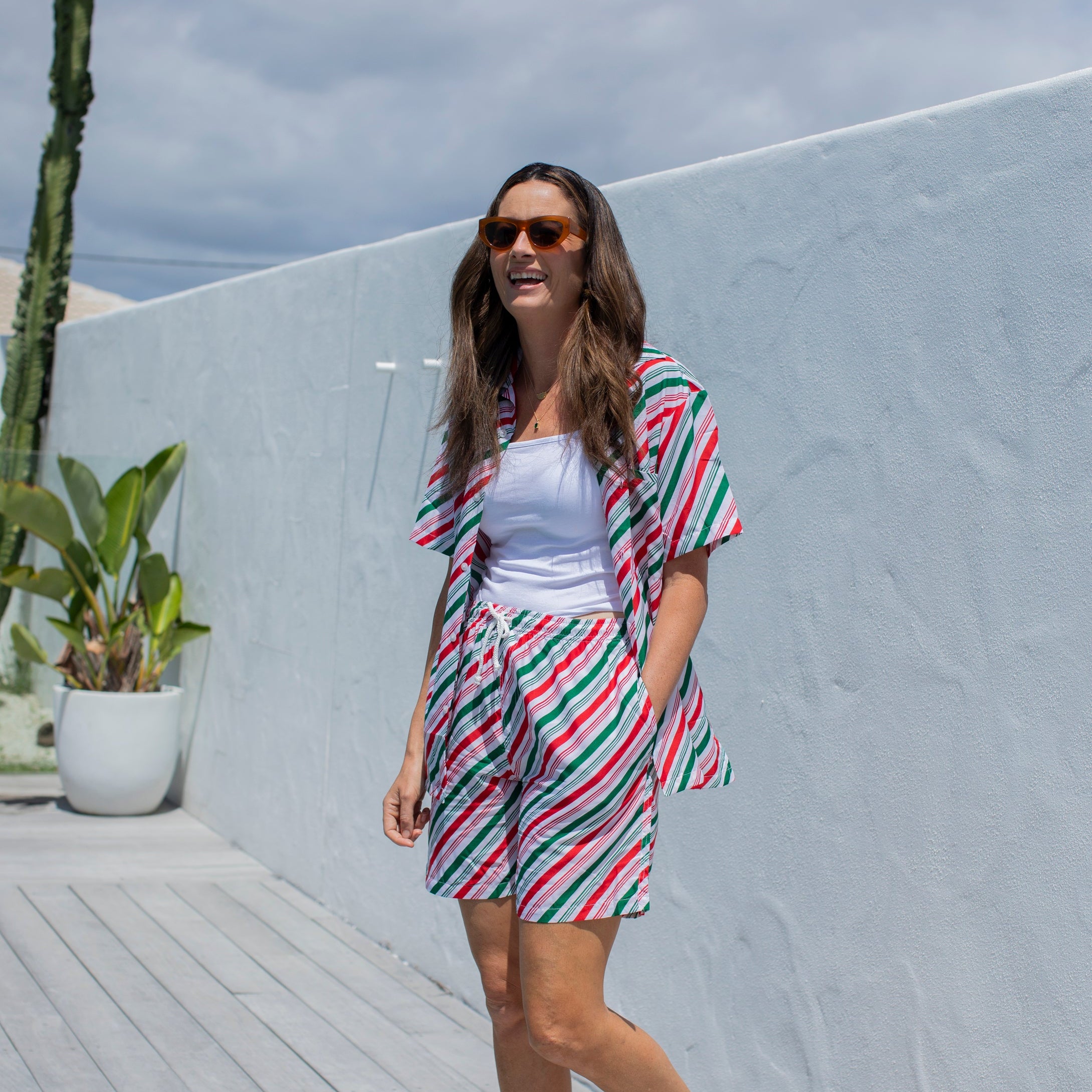 Jolly Stripe Christmas adult shirt with festive red, green, and white stripes paired with casual shorts. | Tropicool Clothing
