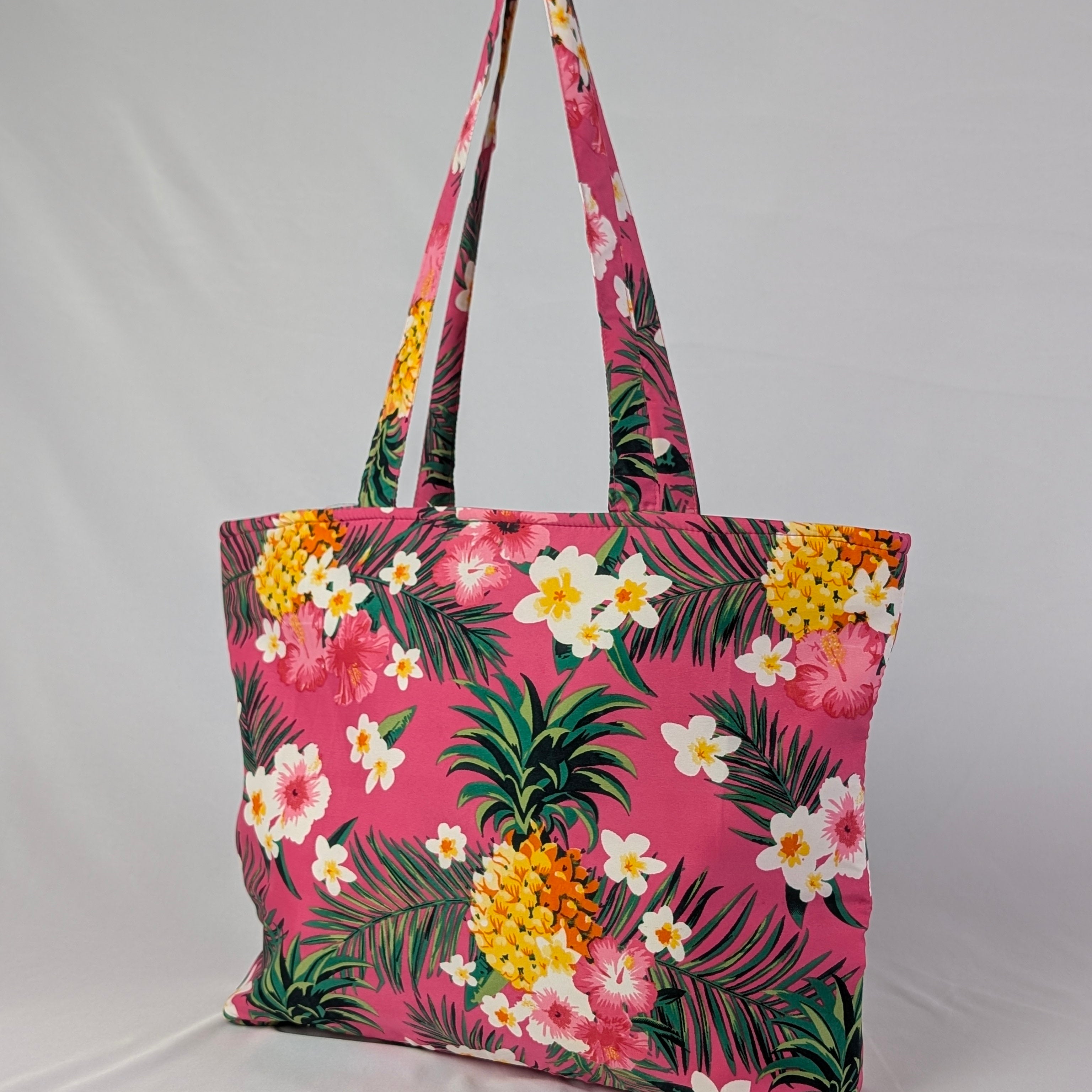 Tropicool Tote Bag with yellow pineapples, white and pink flowers, green leaves on a pink tropical print. | Tropicool Clothing