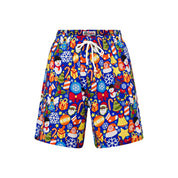 Blue Christmas shorts featuring snowflake, Santa face, gift, and ornament patterns; festive holiday style. | Tropicool Clothing