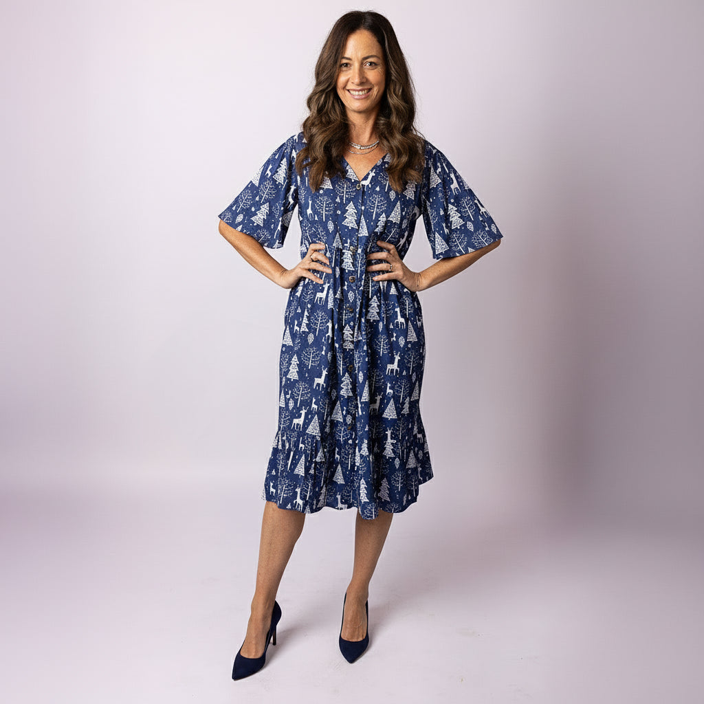 Full-length view of Tropicool Alice Reindeer Navy Christmas dress with flared hem and white reindeer pattern.