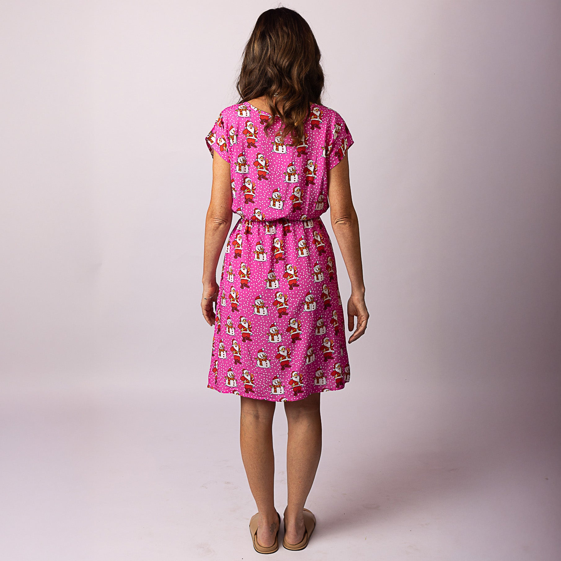 Back view of the Alice Santa Polka Pink Adult Dress featuring lightweight fabric and all-over Santa print – festive women’s Christmas outfit by Tropicool
