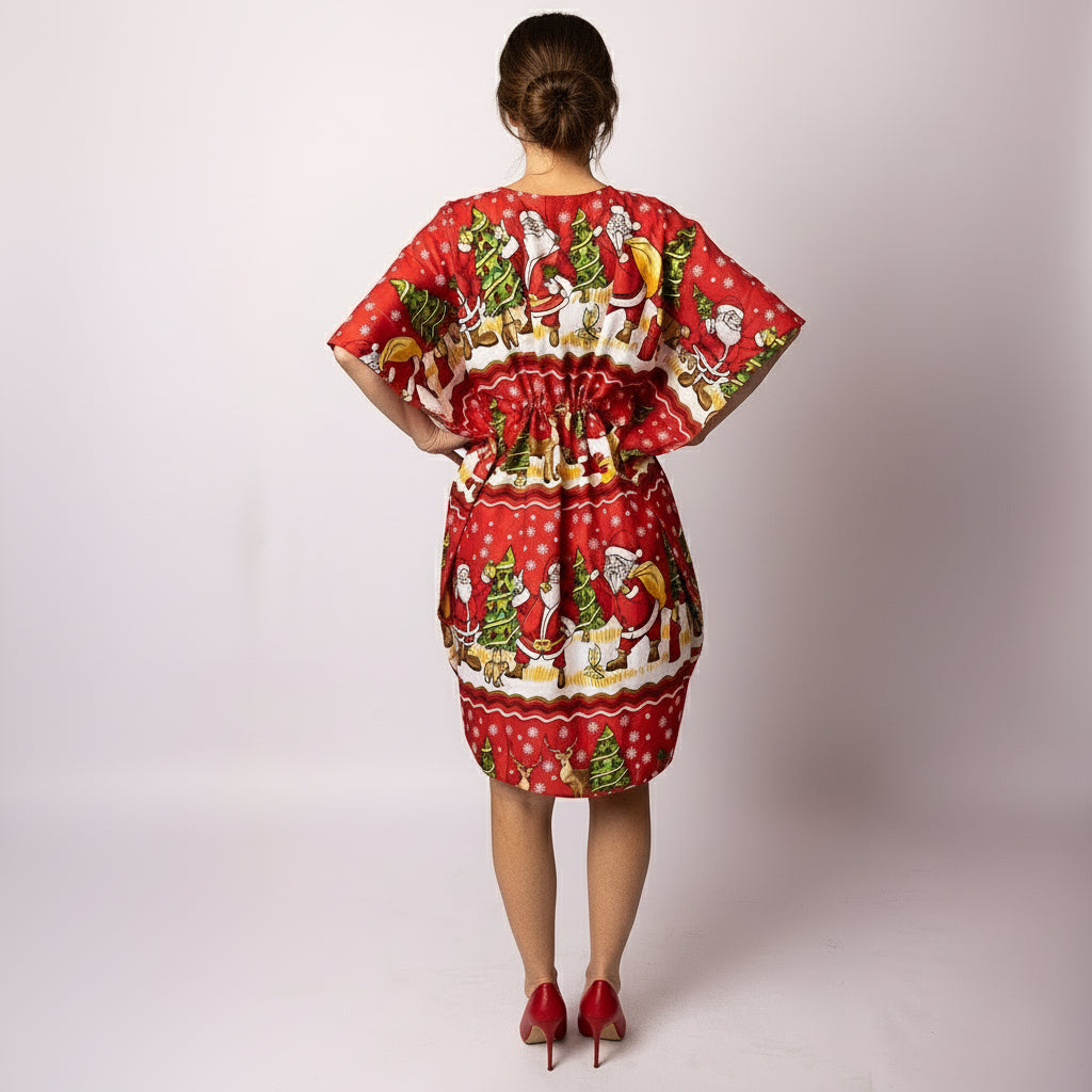 Back view of woman wearing the Tropicool Happy Santa Red Kaftan featuring a bold all-over Santa Christmas pattern. Lightweight and comfortable for warm-weather festivities.