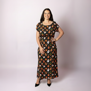 Woman wearing the Tropicool Celyn Jingleverse adult Christmas dress in a full-length studio photo rick & morty 