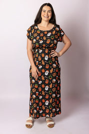 Woman wearing Tropicool Celyn Jingleverse Adult Dress – black Christmas dress with Rick and Morty 