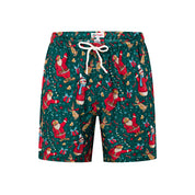 Green adult shorts with festive Santa, snowman, gingerbread men, and present prints; holiday tropical style. | Tropicool Clothing